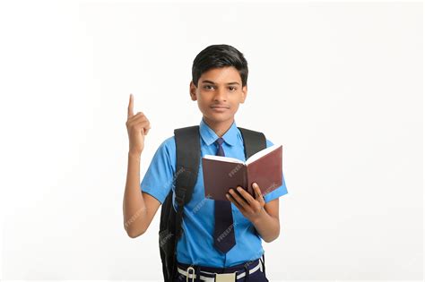 Premium Photo Indian School Boy In Uniform And Reading Diary On White