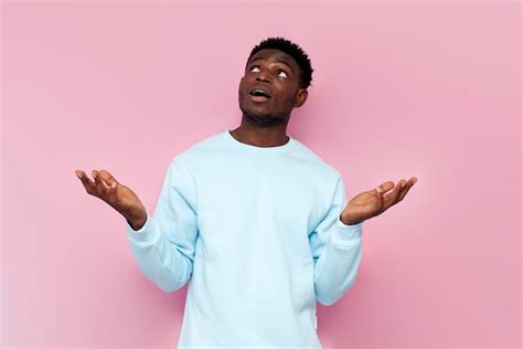 Premium Photo Surprised African American Man In Blue Sweater Catches