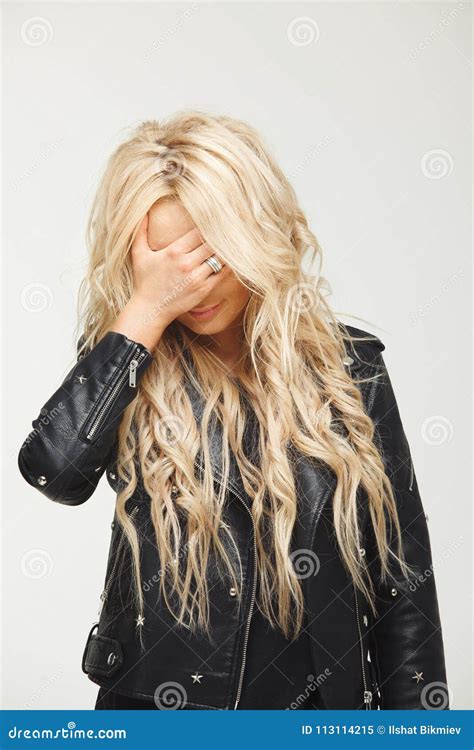Close Up Portrait Of A Blonde Woman With Long Hair Covering Her Face