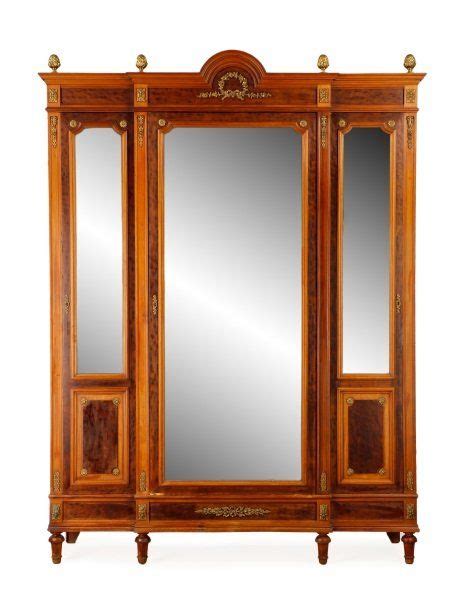 An Antique Wooden Armoire With Mirrors On It