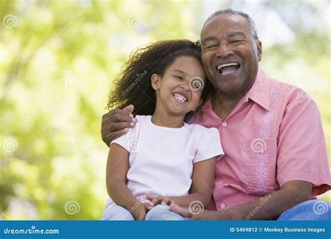 Grandfather And Granddaughter Outdoors Smiling Stock Photography