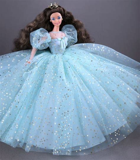 A Barbie Doll Wearing A Blue Dress With Gold Stars On It S Skirt And Tiara