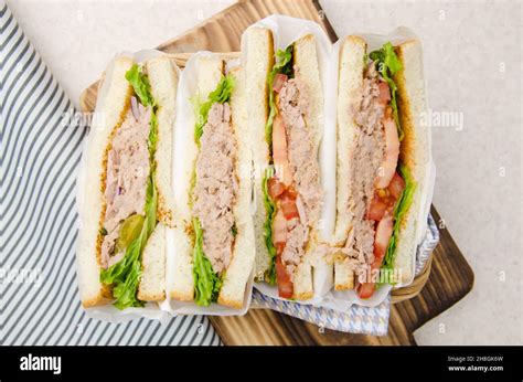 Flat Lay View At Wrapped Tuna Sandwiches With Lettuce Tomatoes Pickles