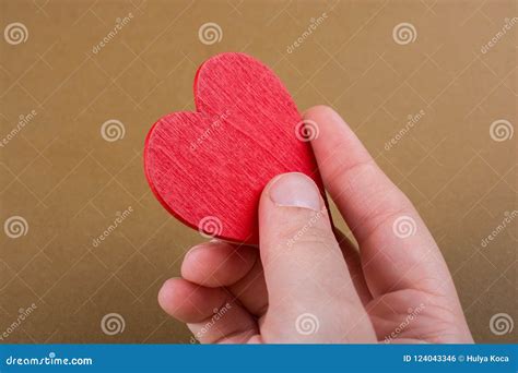 Red Color Heart Shaped Object In Hand Stock Photo Image Of Holding