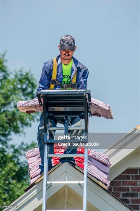 Roofing Contractors Replacing Damaged Roofs After A Hail Storm High Res