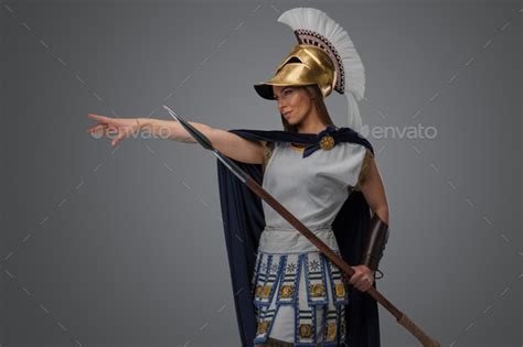 Female greek warrior with spear and golden plumed helmet Stock Photo by ...