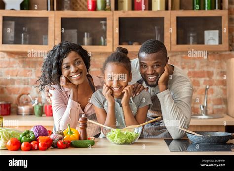 Adorable black family cooking healthy dinner together at kitchen Stock ...