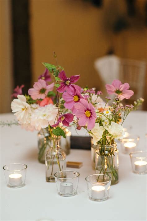 Delicate Individual Flowers In A Glass Jar Act As Simple Yet Elegant