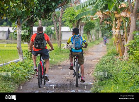 western tourist  indonesian guide riding mountain bikes