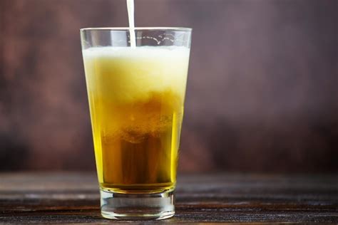 Premium Photo A Large Glass Of Cold Light Beer With Foam On A Dark