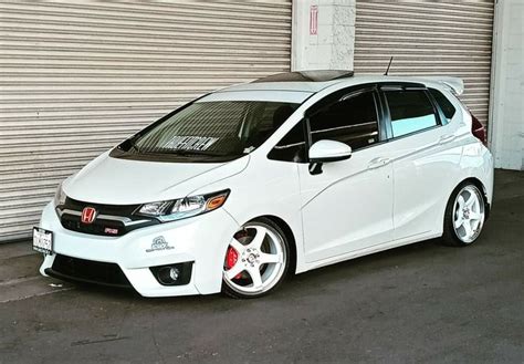 Custom Honda Fit Parked in Front of Garage Door