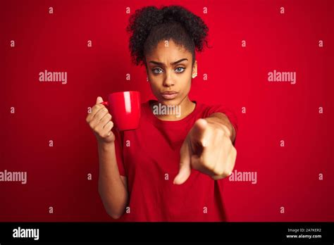 Young African American Woman Drinking A Cup Of Coffee Over Isolated Red