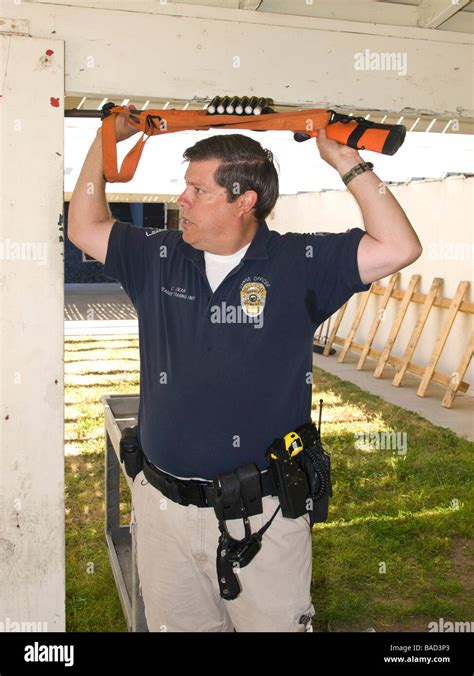 Range Officeer Demonstrates Non Lethal Beanbag Shotgun To The Members Of The Citizen Police