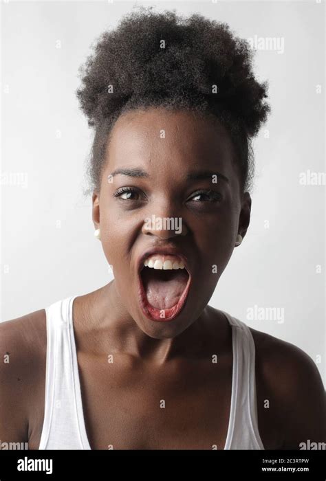 Portrait Of A Young African American Female Screaming Hard Against A