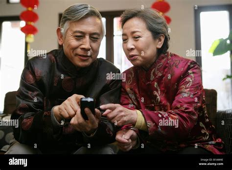 Chinese Mature Couple Making A Phone Call Stock Photo Alamy