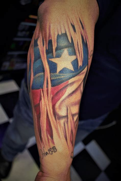 American flag ripping through skin tattoo | TATTOO