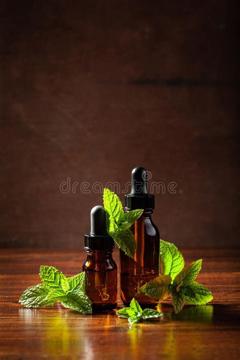 Fresh Mint Peppermint Herb Leaves And Essential Oil In Dropper Bottles