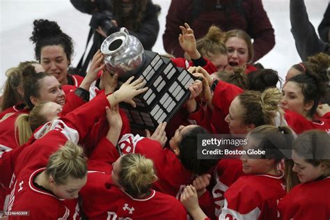 Boston University players celebrate with the Beanpot Trophy after ...