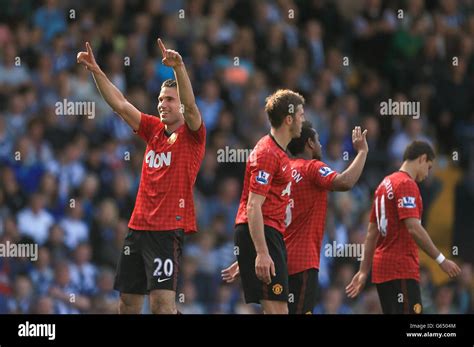 Manchester United's Robin van Persie (left) celebrates scoring their fourth goal of the game ...