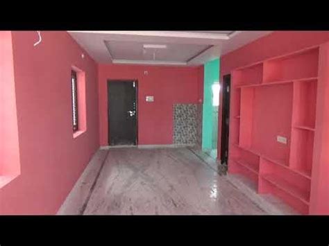 An Empty Room With Pink And Green Walls