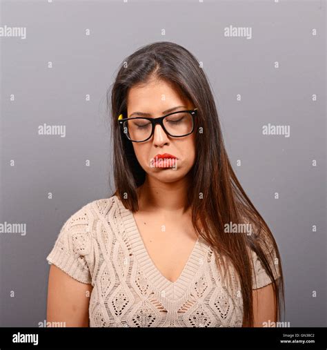 Portrait Of A Sad Woman Against Gray Background Stock Photo Alamy