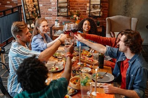 Premium Photo Diverse Group Of Friends Clinking Wine Glasses While