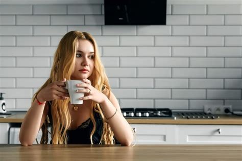 Premium Photo Beautiful Blonde Woman Drinks Coffee