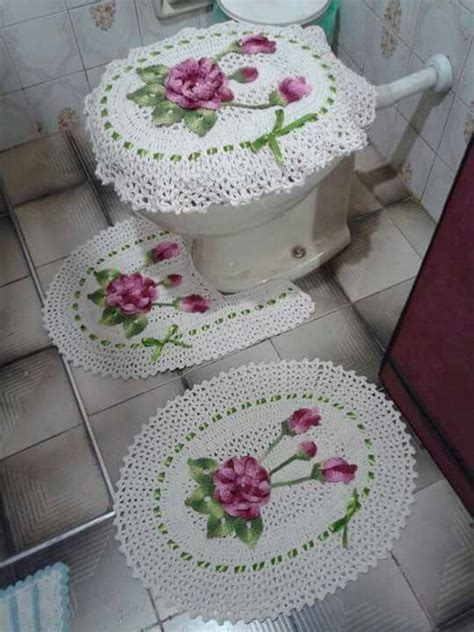 Three White Doily With Pink Flowers On Them Sitting On The Floor Next