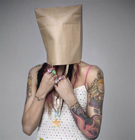 A Woman Holding A Paper Bag Over Her Face