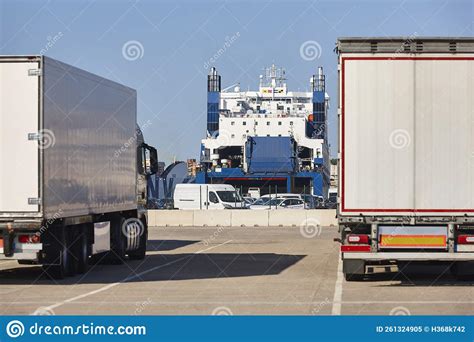 Transportation And Logistic Industry Trucks And Vessel In The Harbor