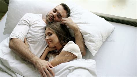 Young Beautiful And Loving Couple Kiss And Hug Into Bed While Waking Up