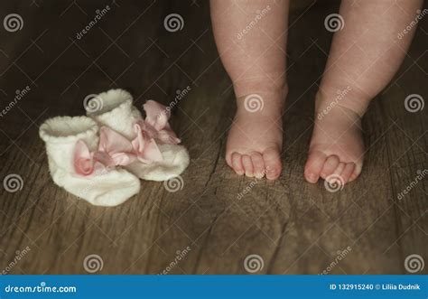 Legs Of Newborn Baby Close Up On Wooden Background Stock Photo Image