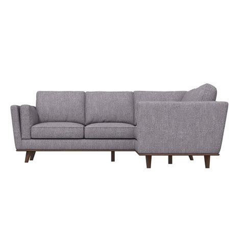 a gray sectional couch sitting on top of a white floor