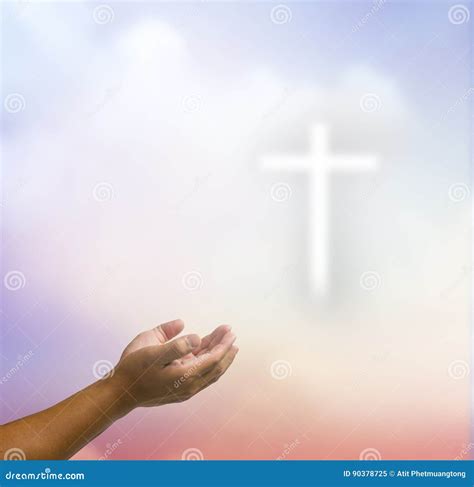 Open Hands Praying The Cross On Blur Sky Background Stock Image