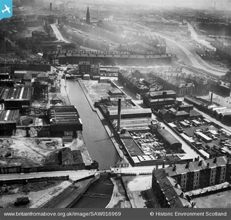 An Old Black And White Photo Of A City With Lots Of Buildings In The