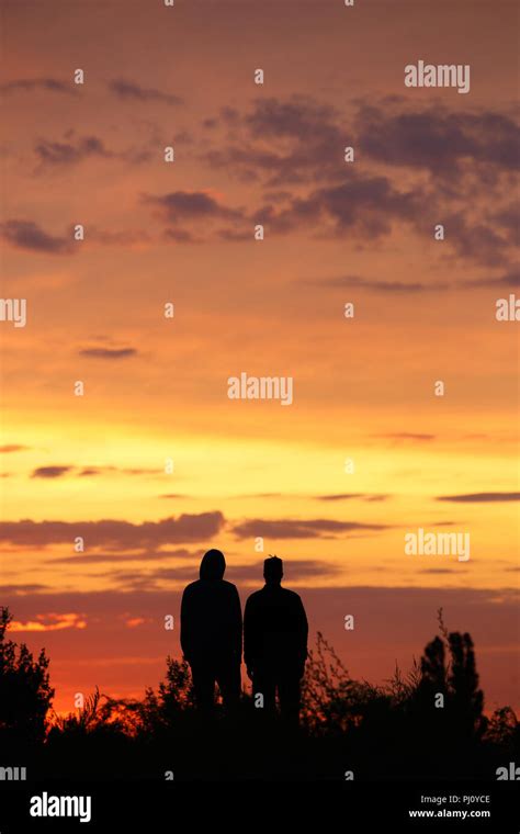Silohuette Of Two Gay Men Staring At The Sun Outdoor In The Evening Couple Of Men Looking At