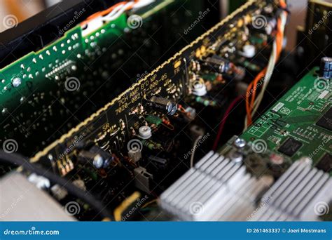 Some Green And Black Circuit Boards In An Open Electronic Device With