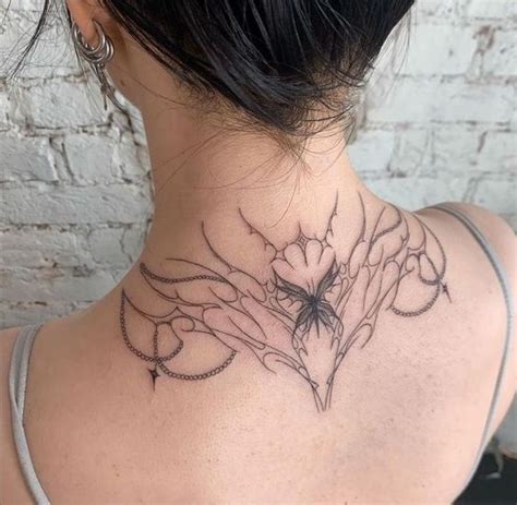 A Woman With A Tattoo On Her Back Neck