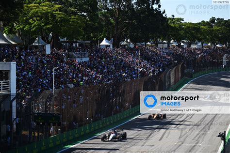 Daniel Ricciardo AlphaTauri AT04 Leads Oscar Piastri McLaren MCL60