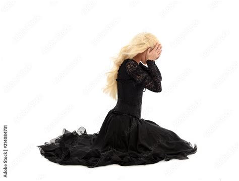 Full Length Portrait Of Blonde Girl Wearing Corset And Long Black Gown Isolated On White Studio