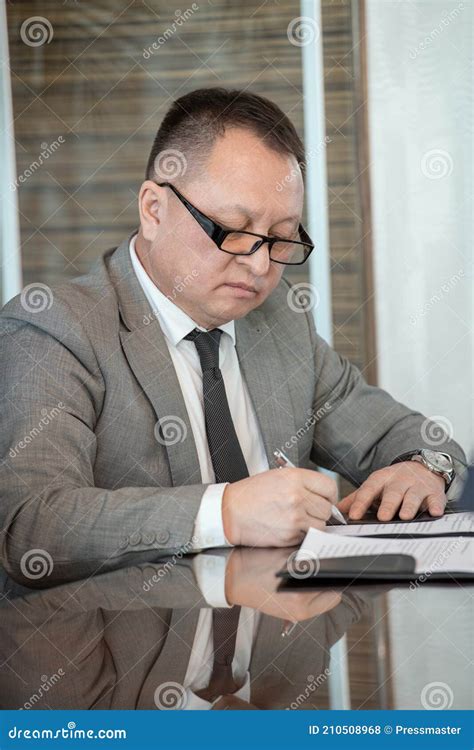 Serious Mature Delegate In Elegant Suit Signing Contract Of Business