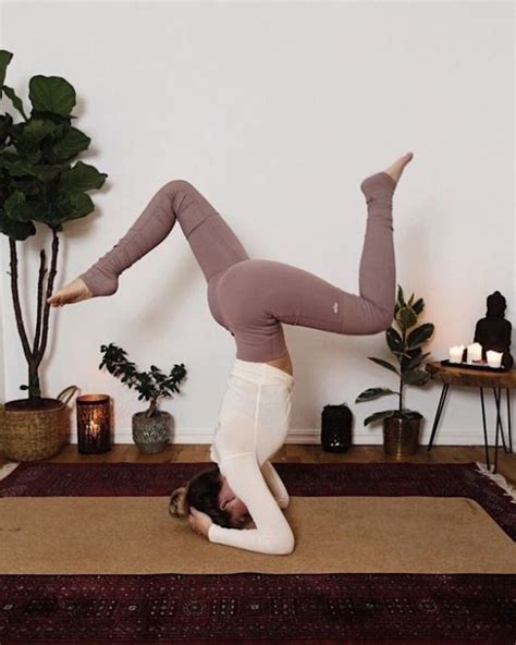 A Woman Doing A Handstand On Top Of A Rug