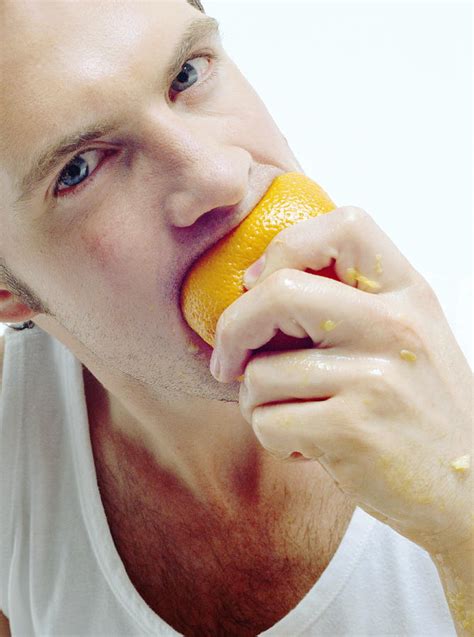 Man Eating Orange Photograph By Jason Kelvin Science Photo Libray