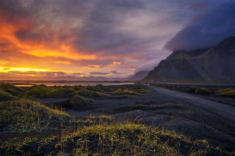 Camino de ripio al atardecer con la montaña vestrahorn en el fondo