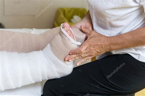 Woman Bandaging Patients Legs — Stock Photo © Vpardi 113158490