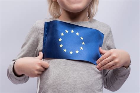 Premium Photo Child Holds Flag Of European Union Close Up Traveling