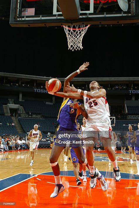 Monique Currie Of The Charlotte Sting Shoots Against Lisa Leslie Of