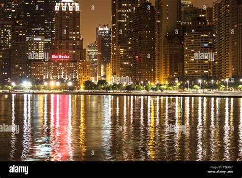 Chicago Skyline At Night Featuring The Drake Hotel Along Lake Michigan