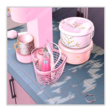 The Kitchen Counter Is Covered With Pink Dishes And Utensils Along