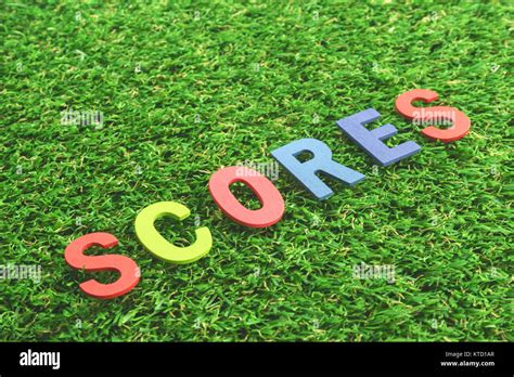 Colorful Wooden Alphabet Word Scores On Green Grass Background Stock